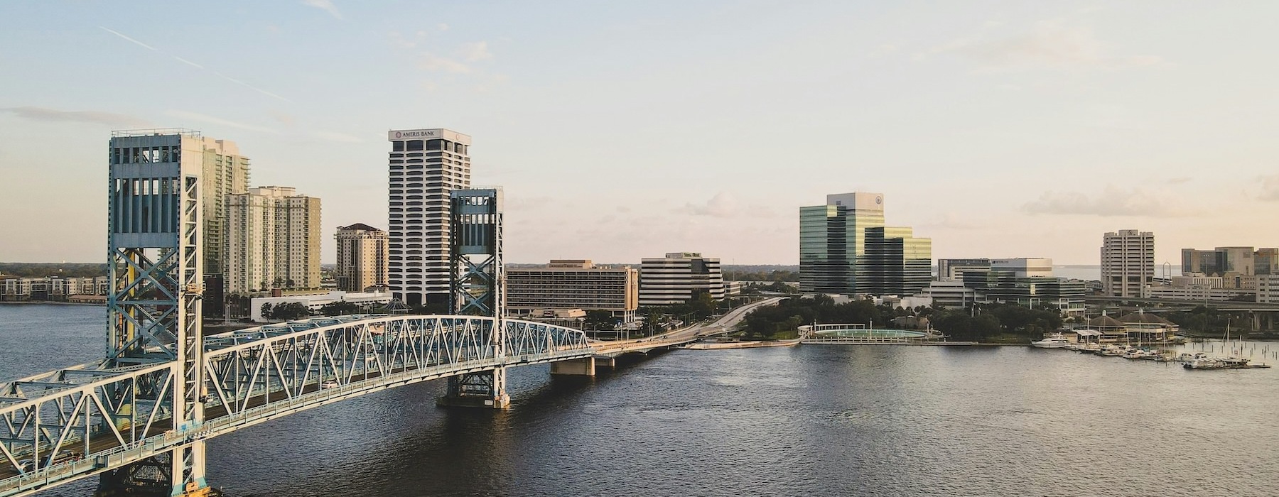 a bridge over water heading into a city