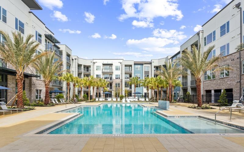 a pool in a courtyard between buildings