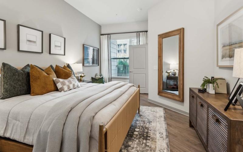 a bedroom with a bed and a mirror